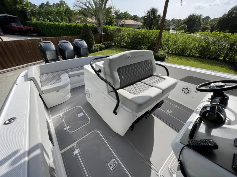 Slide: The Image of 2014 Midnight Express 37 Open boat interior with seating and triple outboard engines. - 31