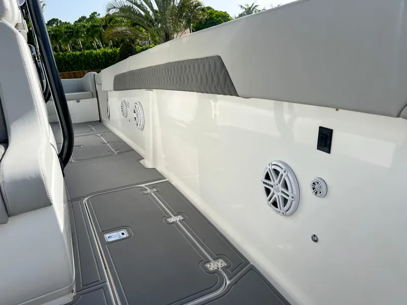 Slide: The Image of 2014 Midnight Express 37 Open boat interior with speakers and cushioned seating. - 32