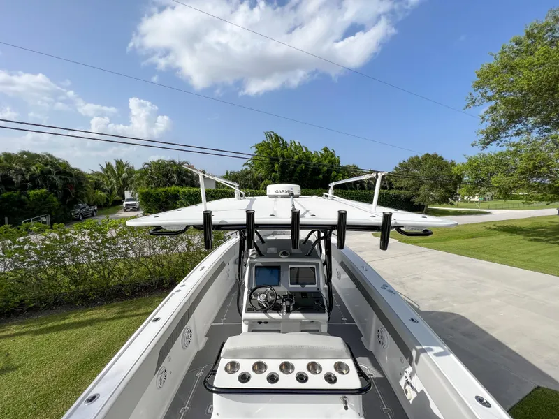 Slide: The Image of 2014 Midnight Express 37 Open boat with advanced navigation system, parked on a sunny day. - 35