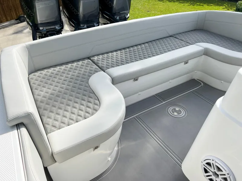 Slide: The Image of 2014 Midnight Express 37 Open boat interior with cushioned seating and diamond-stitched upholstery. - 37