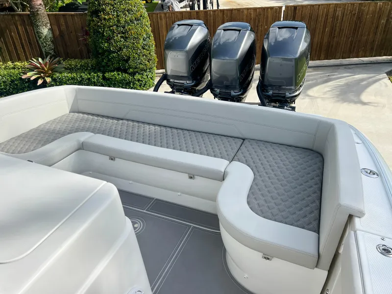 Slide: The Image of 2014 Midnight Express 37 Open boat with triple outboard engines and cushioned seating. - 39