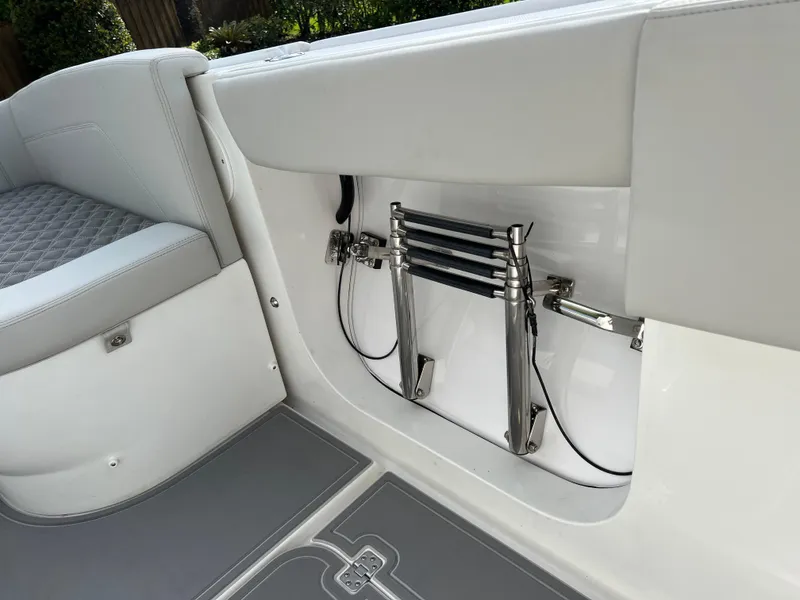 Slide: The Image of 2014 Midnight Express 37 Open boat interior with foldable ladder and cushioned seating. - 42