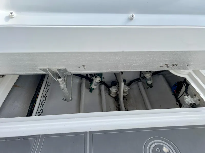 Slide: The Image of 2014 Midnight Express 37 Open boat storage compartment with visible plumbing. - 43