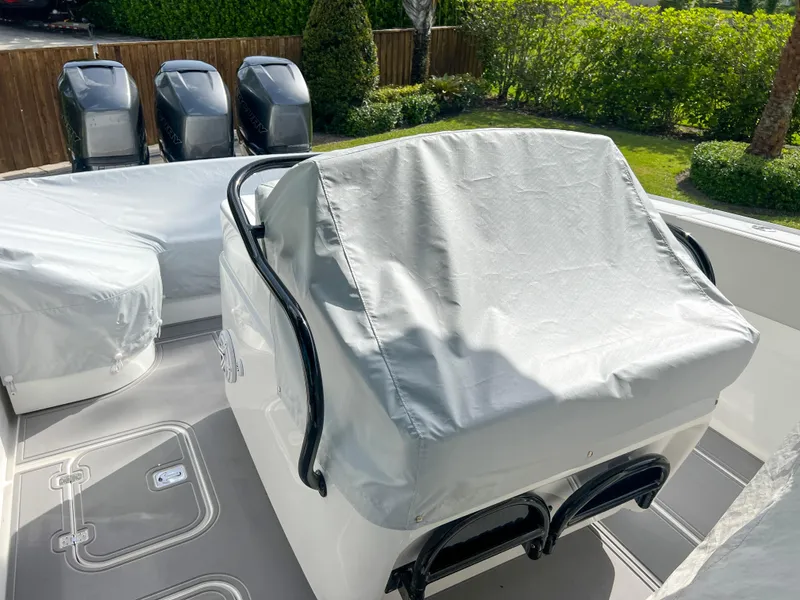Slide: The Image of 2014 Midnight Express 37 Open boat with covered seating and engines. - 49