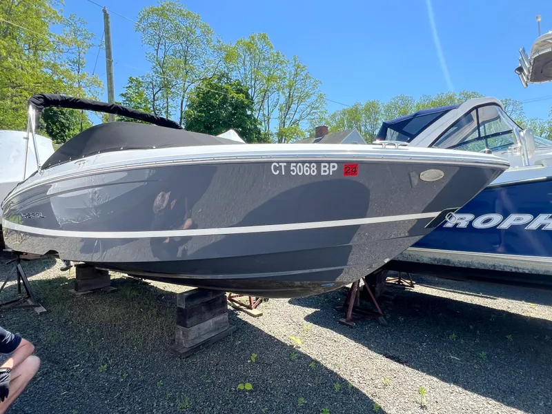 Slide: The Image of 2022 Regal LX2 boat on stands, side view, outdoors, with registration number CT 5068 BP. - 0