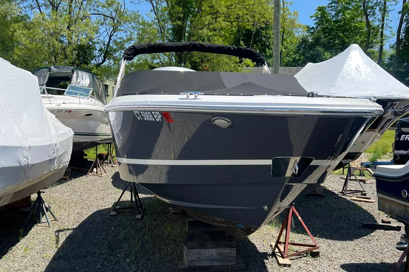 Slide: The Image of 2022 Regal LX2 boat on stands in a marina. - 1