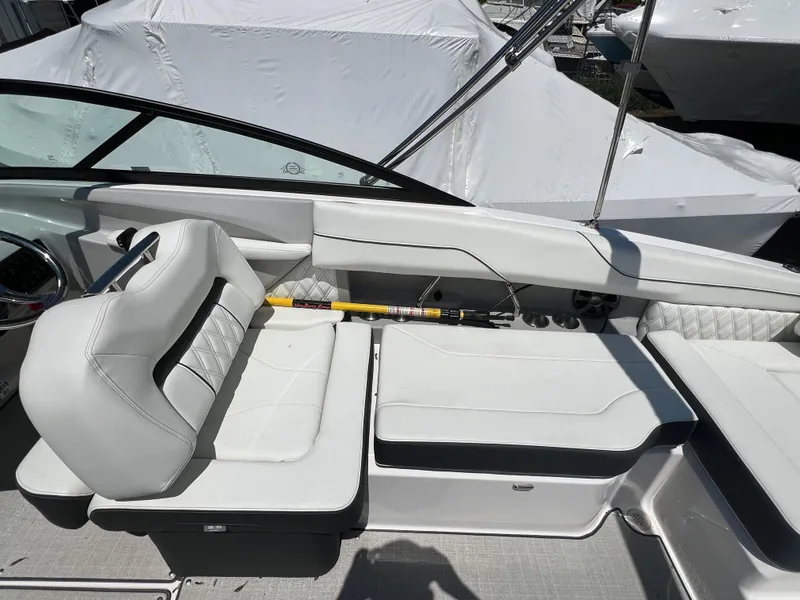 Slide: The Image of 2022 Regal LX2 boat interior with white leather seating and modern design. - 15