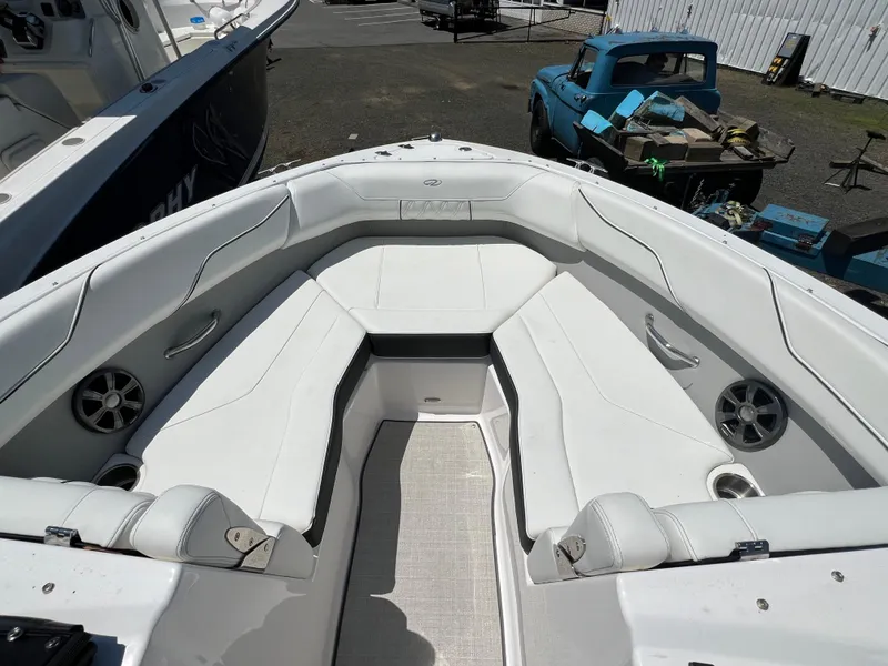 Slide: The Image of 2022 Regal LX2 boat with white cushioned seating and built-in speakers. - 18