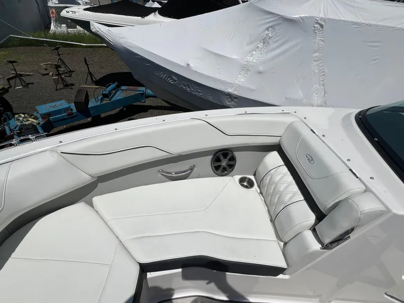 Slide: The Image of 2022 Regal LX2 boat with white leather seating and cup holder. - 20