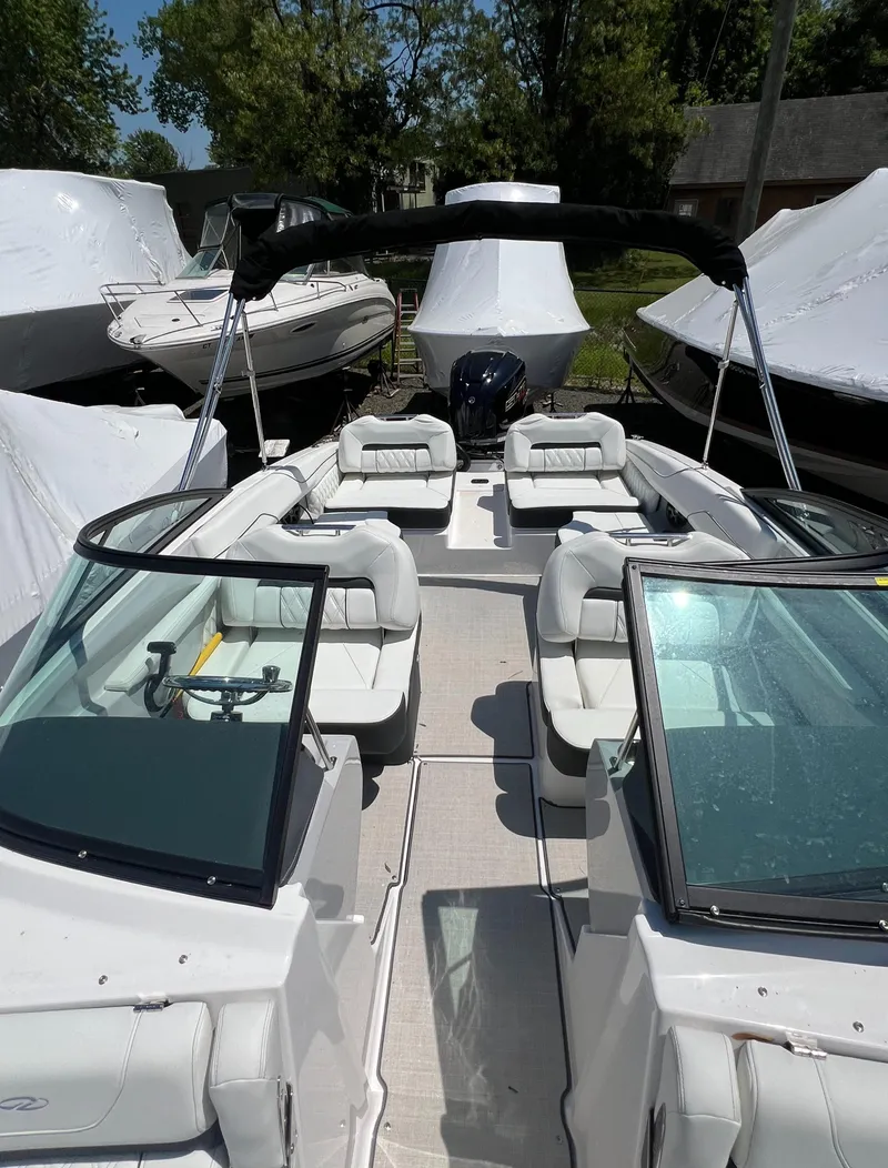 Slide: The Image of 2022 Regal LX2 boat with spacious seating and sleek design. - 21