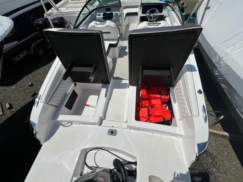 Slide: The Image of 2022 Regal LX2 boat with open storage compartments and life jackets. - 5