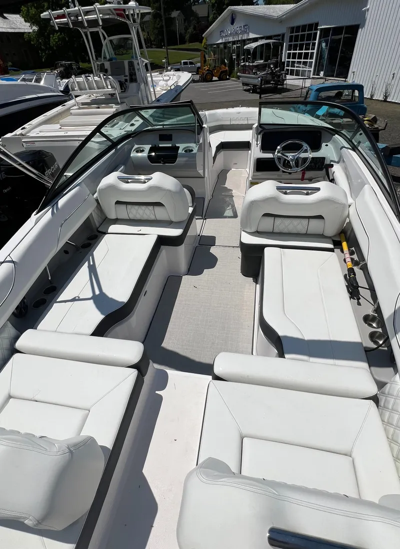 Slide: The Image of 2022 Regal LX2 boat with white interior and dual consoles. - 8