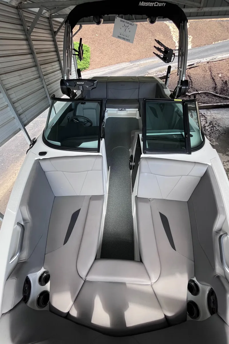 Slide: The Image of 2022 MasterCraft NXT22 boat with sleek interior design and spacious seating under a canopy. - 39