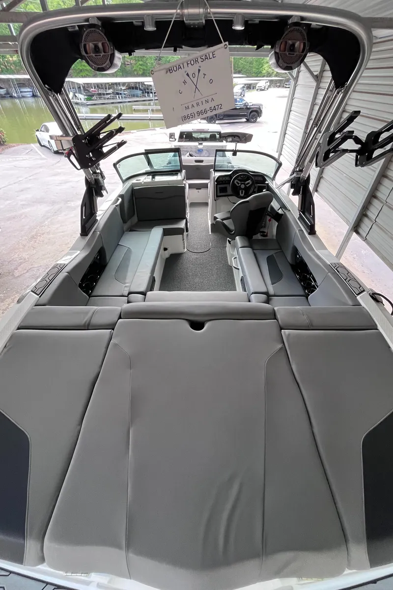Slide: The Image of 2022 MasterCraft NXT22 boat interior with gray seating and modern dashboard. - 44
