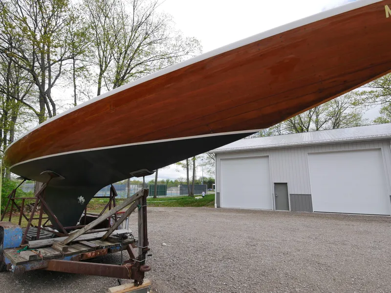 Slide: The Image of 1935 Custom 44' 30-Square Meter Sailing Yacht on a trailer near a white building. - 11