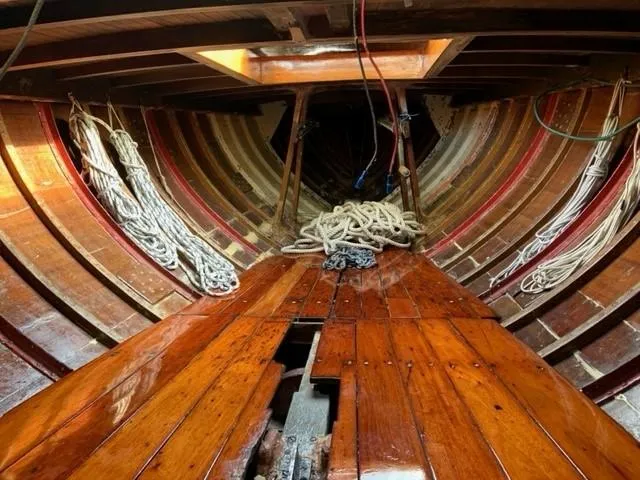 Slide: The Image of Interior of 1935 Custom 44' 30-Square Meter Sailing Yacht with wooden planks and coiled ropes. - 38
