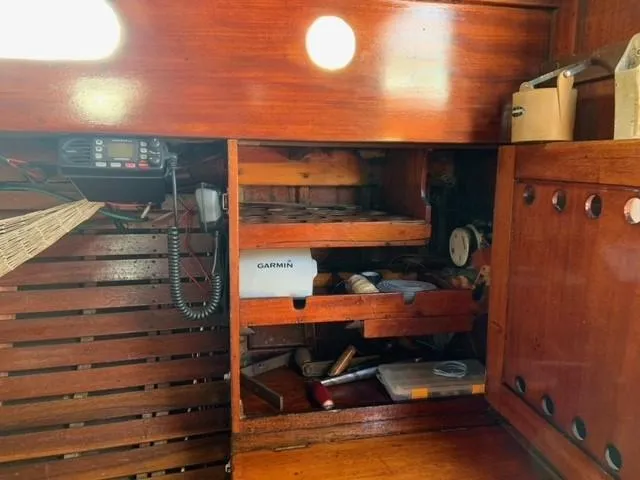 Slide: The Image of Interior of a 1935 Custom 44' 30-Square Meter Sailing Yacht with wooden cabinetry and navigation equipment. - 44