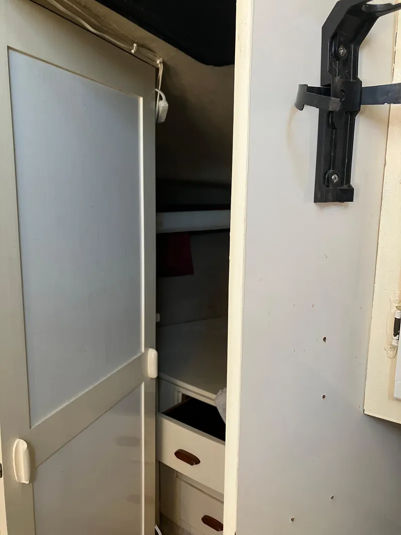 Slide: The Image of 1985 Cruisers Yachts 338 Chateau Vee interior cabin with storage drawers. - 14