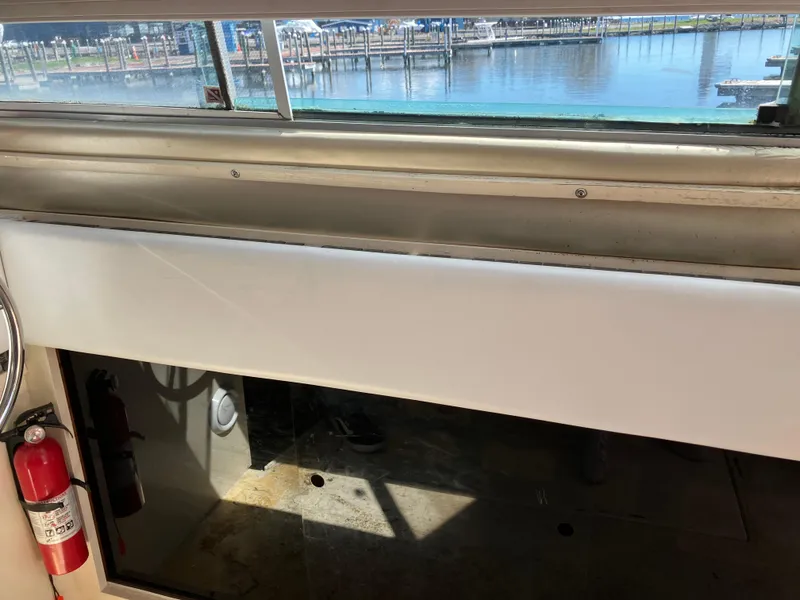 Slide: The Image of Interior view of 1985 Cruisers Yachts 338 Chateau Vee with marina in background. - 15