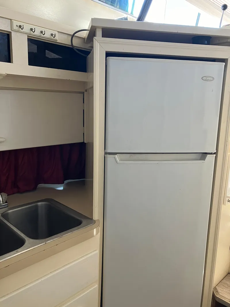 Slide: The Image of 1985 Cruisers Yachts 338 Chateau Vee kitchen with sink and refrigerator. - 16