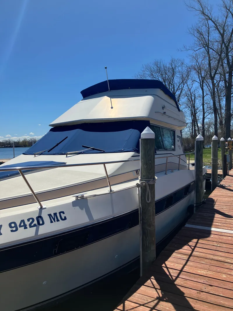 Slide: The Image of 1985 Cruisers Yachts 338 Chateau Vee docked on a sunny day. - 2
