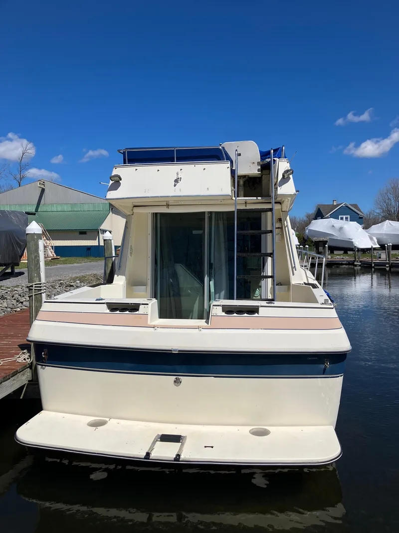 Slide: The Image of 1985 Cruisers Yachts 338 Chateau Vee docked at a marina. - 4