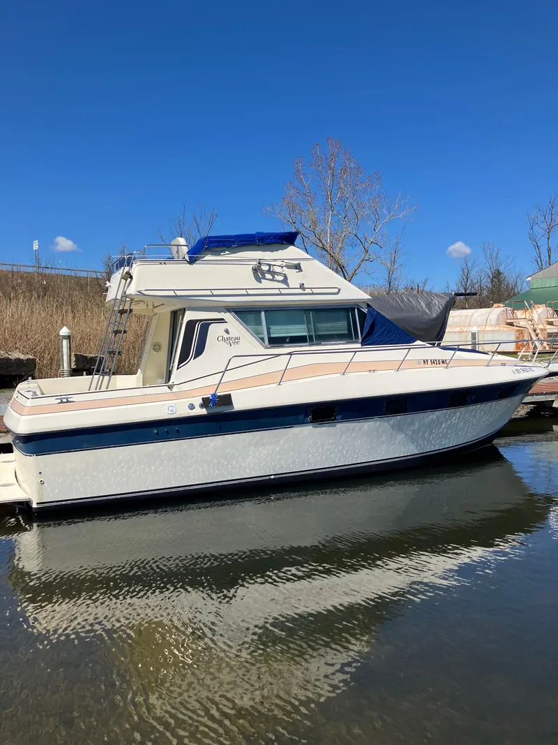 Slide: The Image of 1985 Cruisers Yachts 338 Chateau Vee docked on a sunny day. - 12