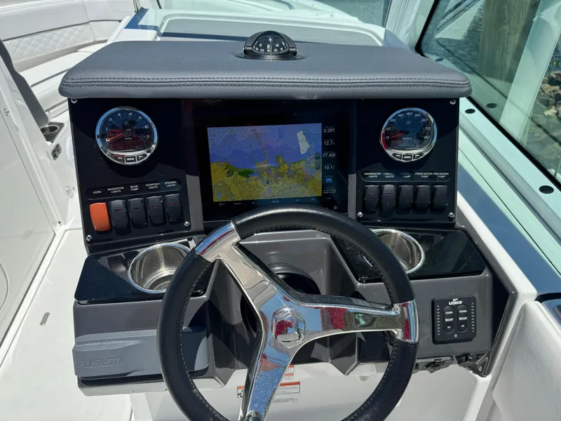 Slide: The Image of 2022 Blackfin 232 boat dashboard with navigation system and controls. - 12