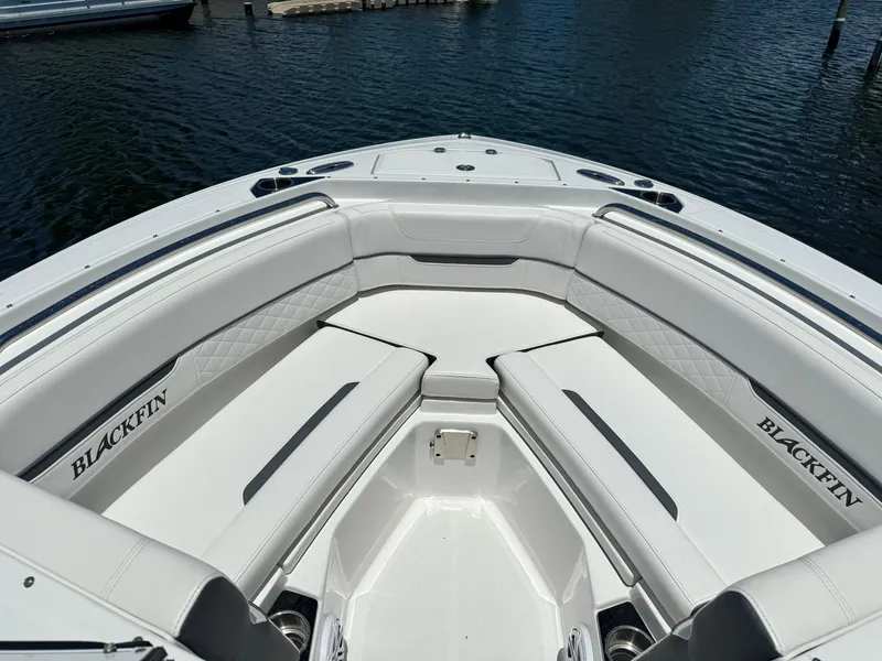 Slide: The Image of 2022 Blackfin 232 boat with white cushioned seating at the bow. - 13