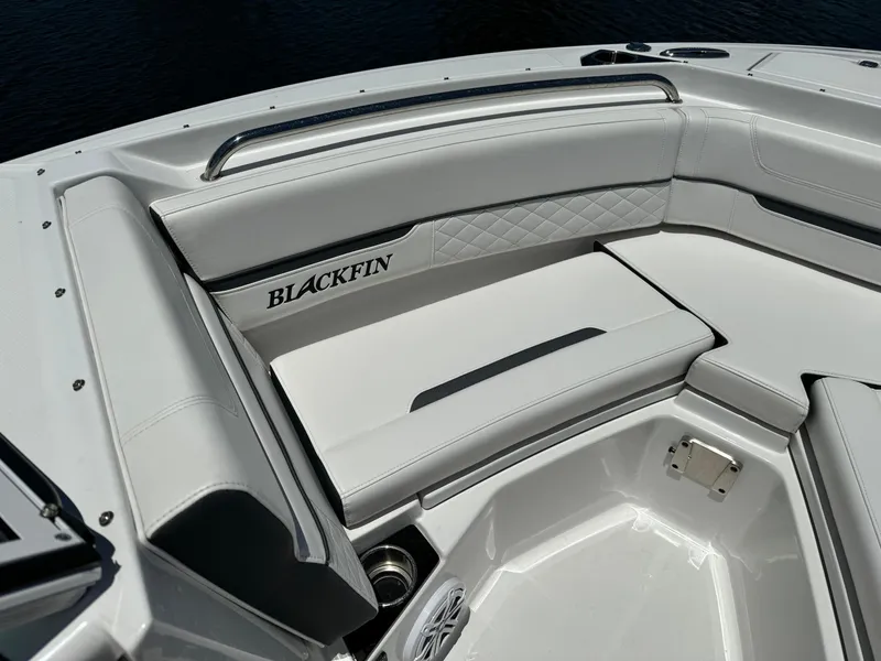 Slide: The Image of 2022 Blackfin 232 boat interior with white cushioned seating and sleek design. - 15