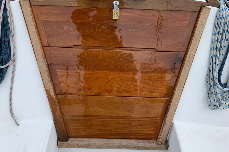 Slide: The Image of Wooden hatch with padlock on 1990 Catalina 30' Tall Rig sailboat. - 4