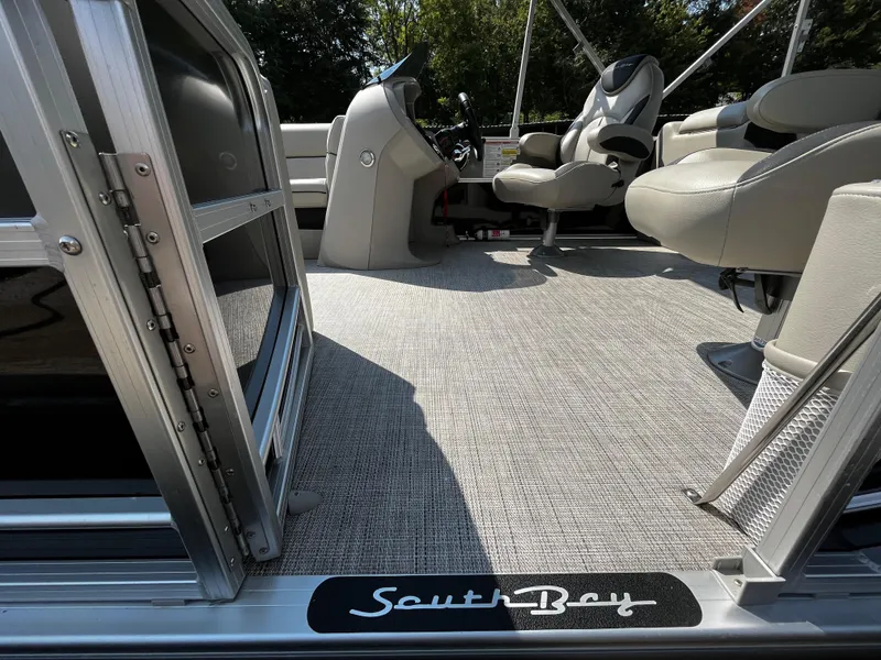 Slide: The Image of 2022 South Bay 224 RS LE pontoon boat interior with seating and helm. - 18