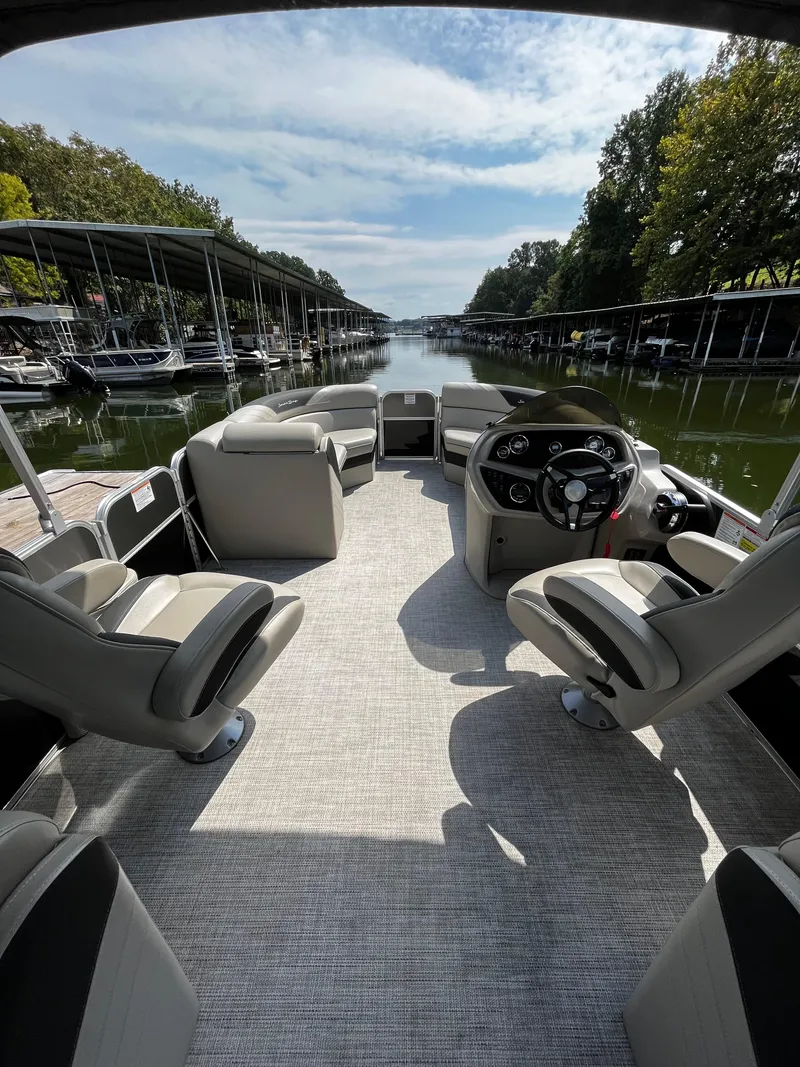 Slide: The Image of 2022 South Bay 224 RS LE pontoon boat interior with helm and seating. - 14