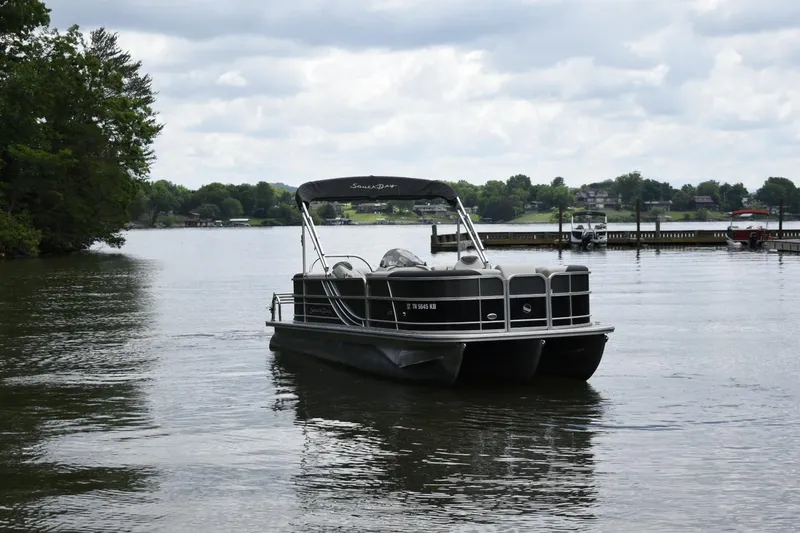 Slide: The Image of 2022 South Bay 224 RS LE pontoon boat on a lake. - 3