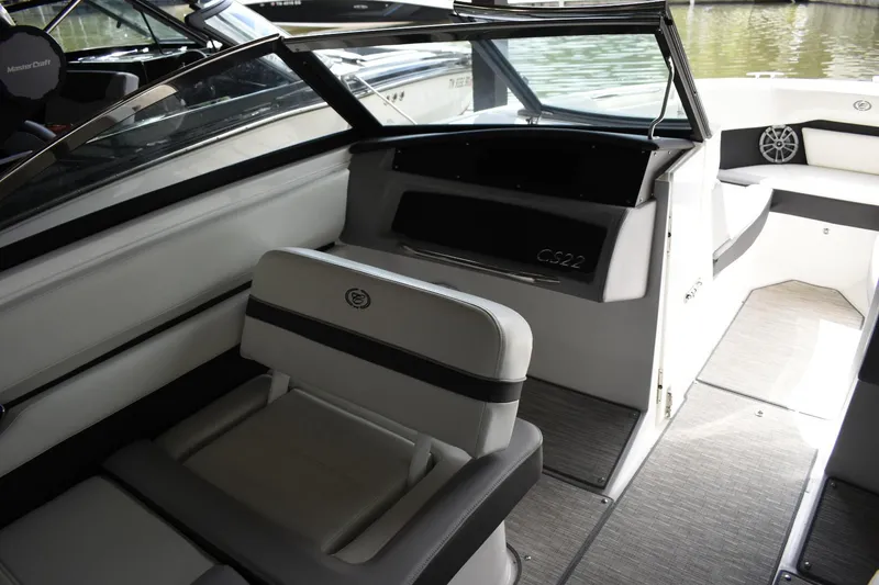 Slide: The Image of 2023 Cobalt CS22 boat interior with white and black seating, and modern design. - 10
