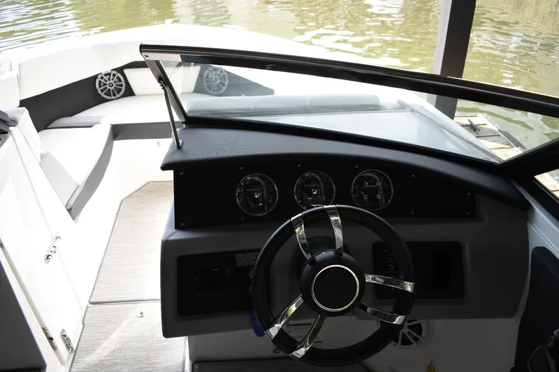 Slide: The Image of 2023 Cobalt CS22 boat dashboard with steering wheel and gauges. - 12