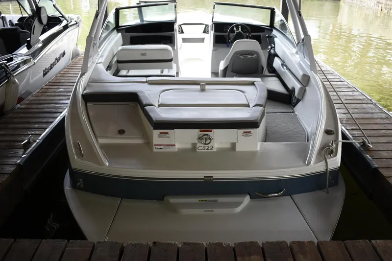 Slide: The Image of 2023 Cobalt CS22 boat docked, rear view showing spacious seating and sleek design. - 3