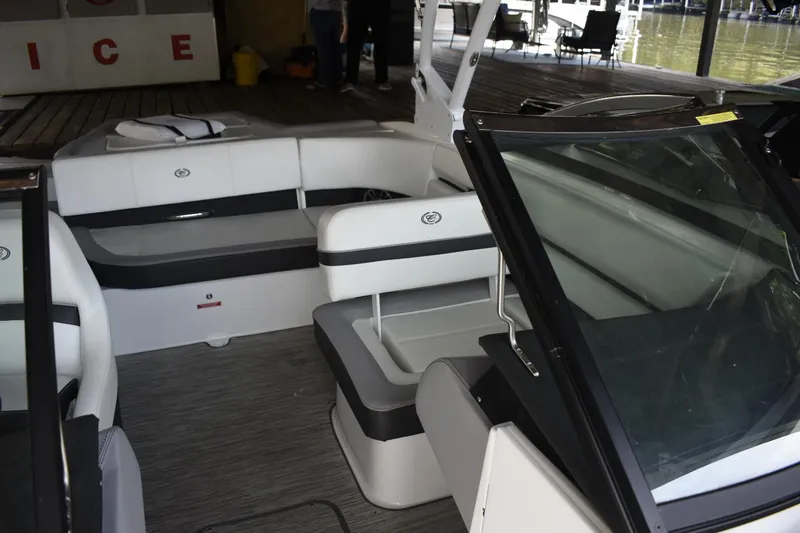 Slide: The Image of 2023 Cobalt CS22 boat interior with white and gray seating. - 9
