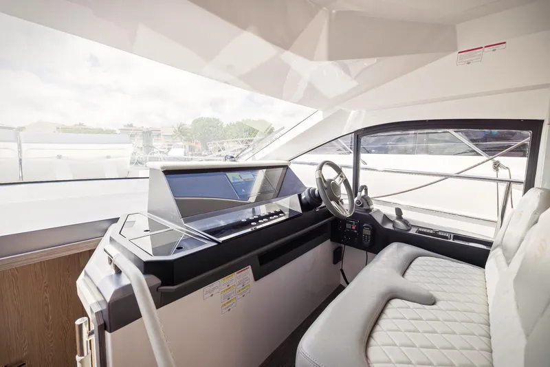 Slide: The Image of Interior helm of 2024 Sessa Marine Fly 48 yacht with modern controls and seating. - 14