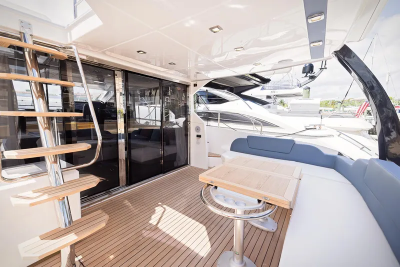 Slide: The Image of Luxurious 2024 Sessa Marine Fly 48 yacht interior with modern seating and wooden flooring. - 17