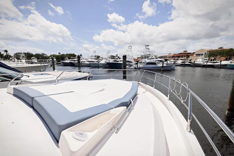 Slide: The Image of 2024 Sessa Marine Fly 48 yacht docked in a marina under a cloudy sky. - 18