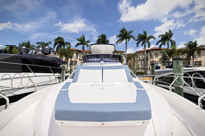 Slide: The Image of 2024 Sessa Marine Fly 48 yacht docked, with palm trees and blue sky background. - 19