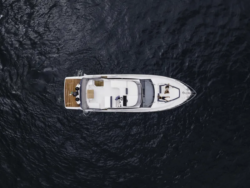Slide: The Image of Aerial view of 2024 Sessa Marine Fly 48 yacht on dark water. - 3