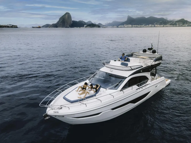 Slide: The Image of 2024 Sessa Marine Fly 48 yacht cruising near scenic coastline. - 4