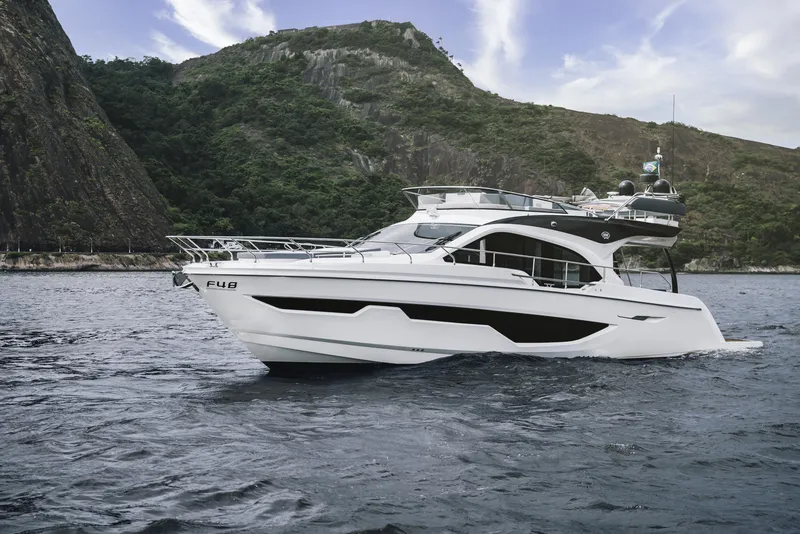 Slide: The Image of 2024 Sessa Marine Fly 48 yacht cruising near rocky coastline. - 5