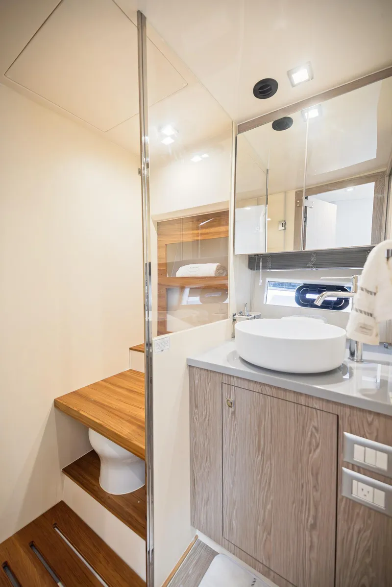 Slide: The Image of Luxurious bathroom in 2024 Sessa Marine Fly 48 yacht with modern fixtures and wood accents. - 8