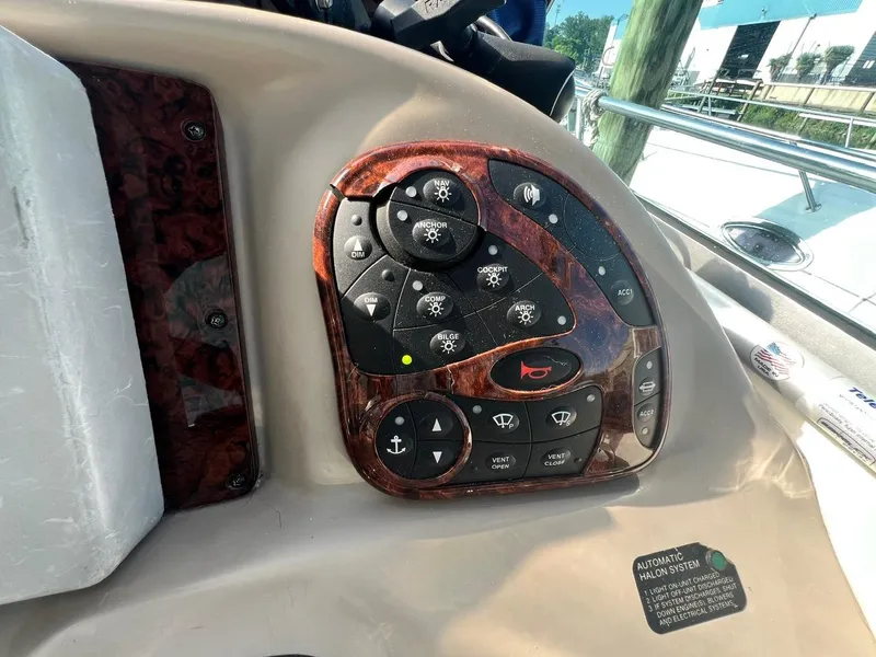 Slide: The Image of Control panel of a 2003 Sea Ray 300 Sundancer boat with various buttons and switches. - 10