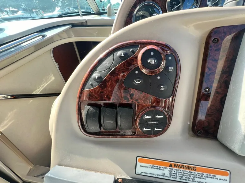 Slide: The Image of Control panel of a 2003 Sea Ray 300 Sundancer boat with woodgrain finish. - 11