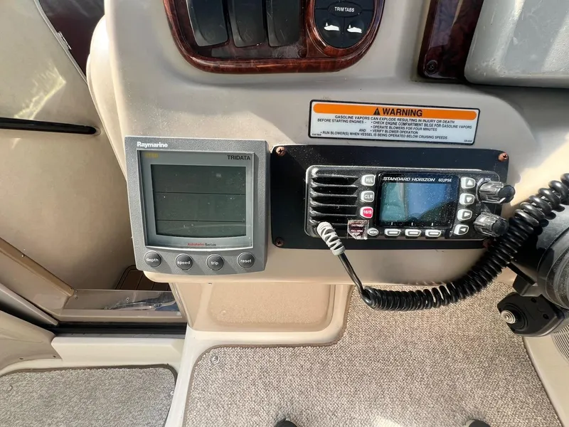 Slide: The Image of Control panel of 2003 Sea Ray 300 Sundancer with navigation and communication devices. - 12