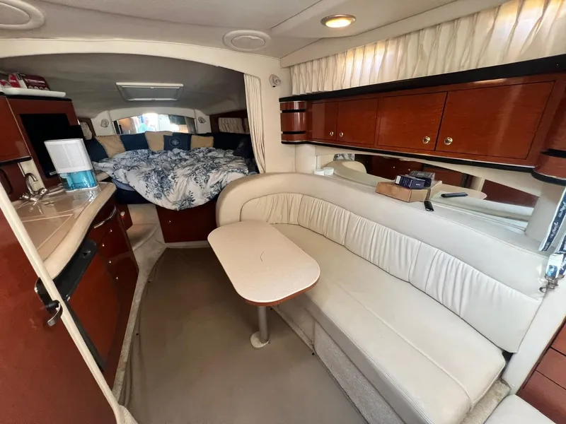 Slide: The Image of Interior of 2003 Sea Ray 300 Sundancer with cozy seating and elegant wood cabinetry. - 17